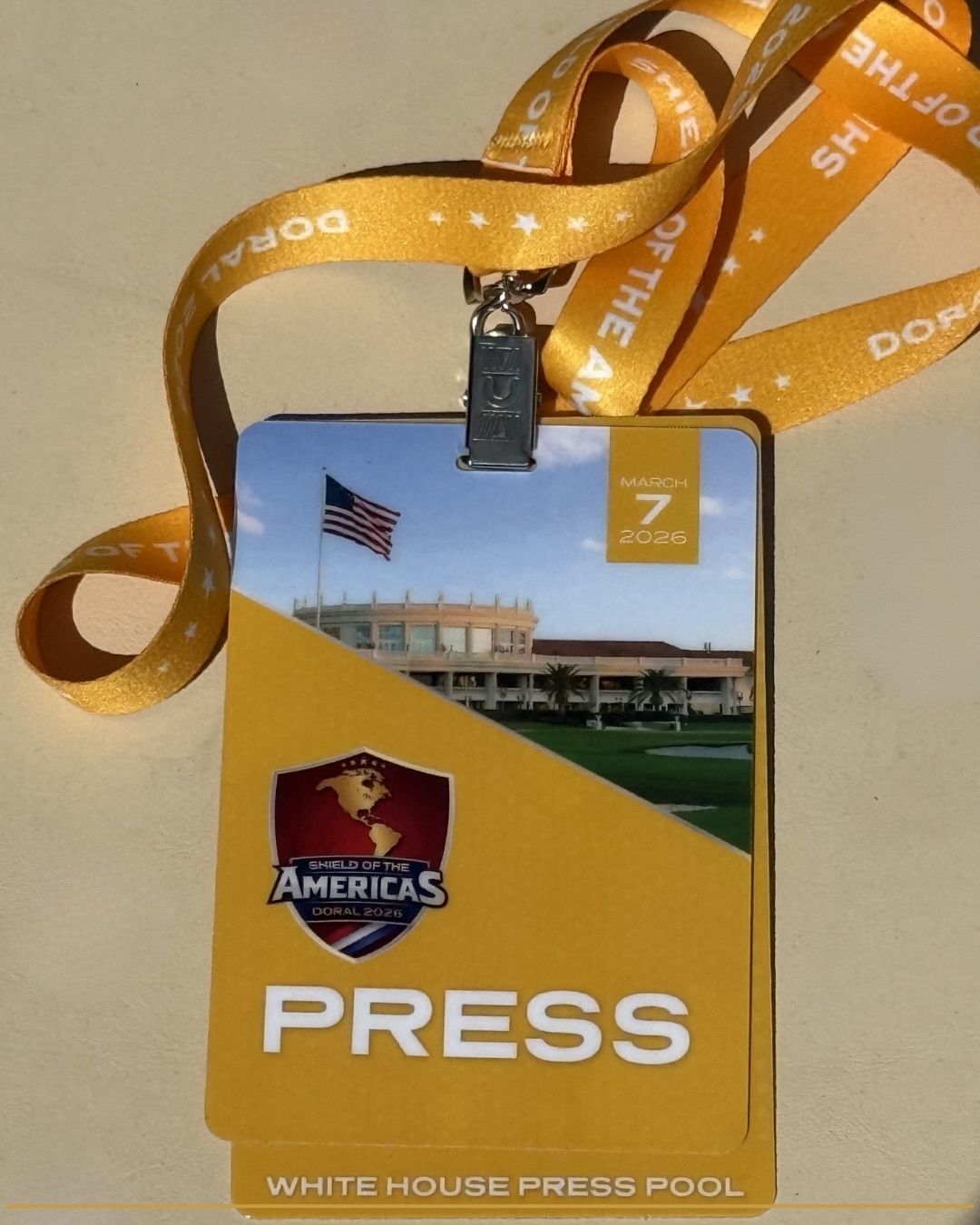 Palm Beach Buzz media credentials displayed at the Shield of the Americas summit at Trump National Doral in Miami during President Donald Trump’s anti-cartel coalition announcement.
