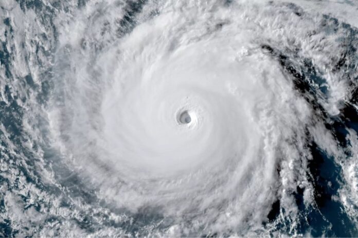 Satellite image of a powerful hurricane swirling over the Atlantic Ocean during hurricane season, showing the storm’s eye and dense cloud bands from space.
