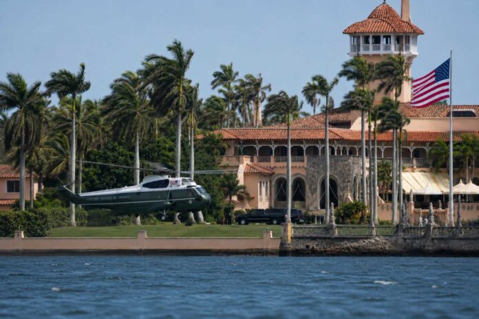 Marine One lands on the lawn of President Donald Trump's Mar-a-Lago estate in Palm Beach, Florida, as viewed from across the Intracoastal Waterway from West Palm Beach.