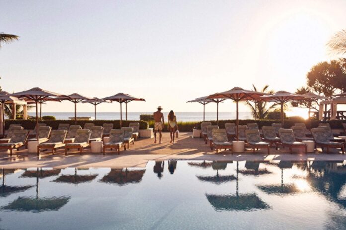 Oceanfront pool at Four Seasons Resort Palm Beach, where guests can relax between spa treatments and enjoy the resort's summer wellness experiences.