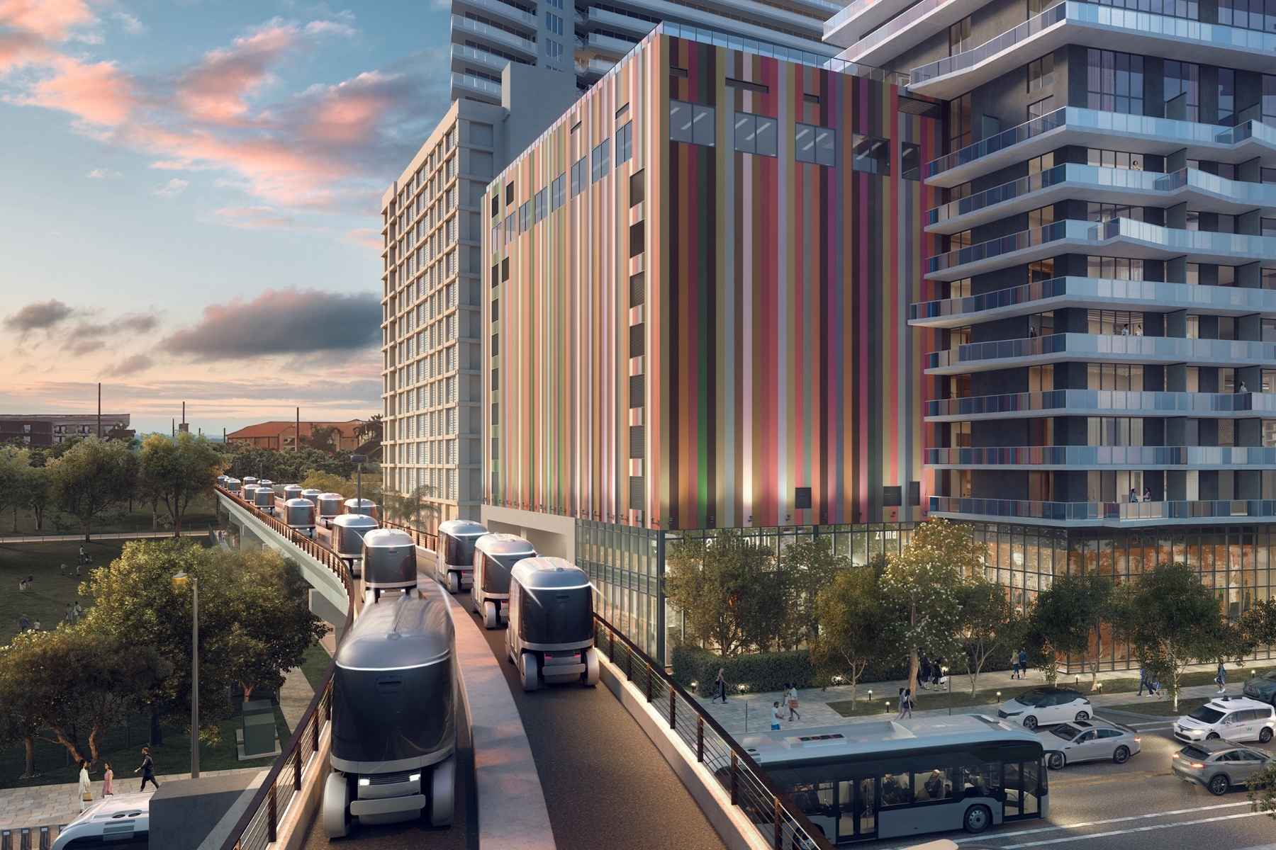 Autonomous Glydways vehicle traveling along a dedicated elevated guideway above city traffic in West Palm Beach.