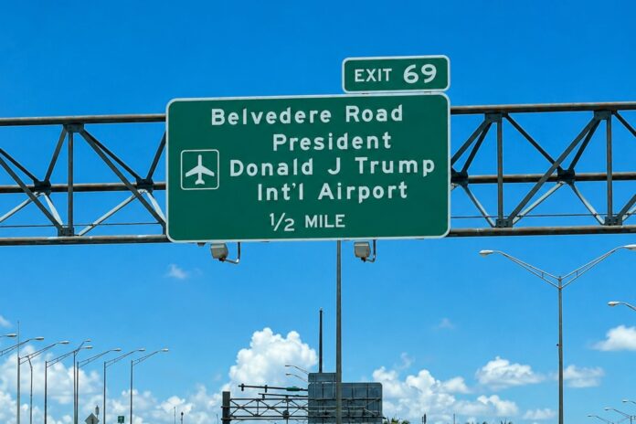 New Interstate 95 highway sign directing drivers to Donald J. Trump International Airport at Exit 69B in Palm Beach County ahead of the airport's official name change.