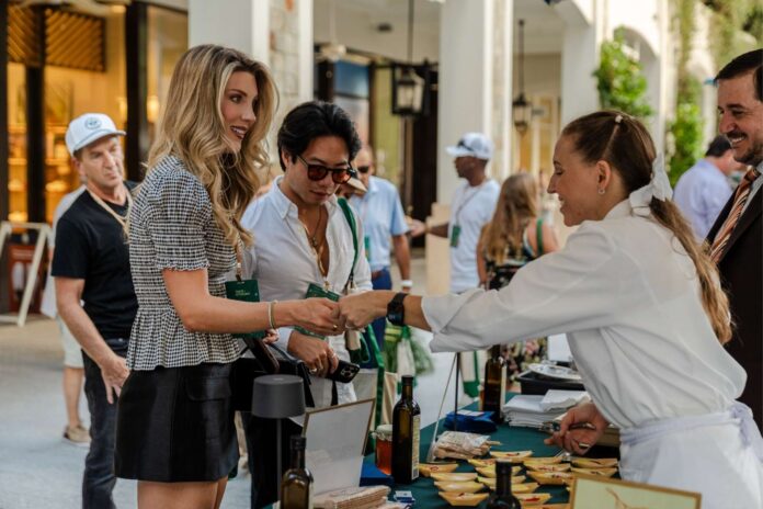 Guests enjoy food tastings during an outdoor event at CityPlace in downtown West Palm Beach.