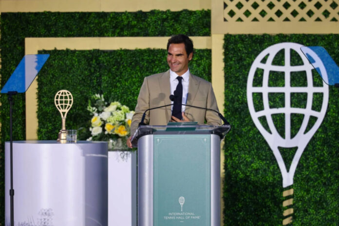 Roger Federer celebrates his induction into the International Tennis Hall of Fame in Newport, Rhode Island.