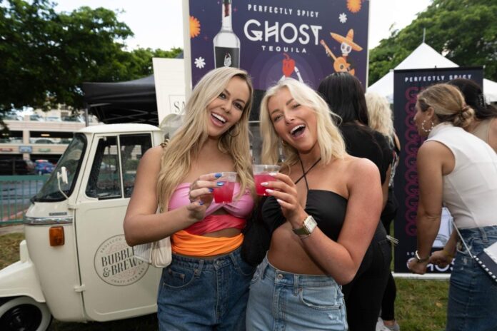 Two guests raise their drinks at The Tequila Festival in Boca Raton