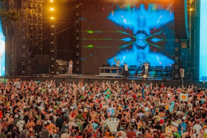 Crowd watches a performance at Okeechobee Music & Arts Festival; headline says the festival will not return in 2027.