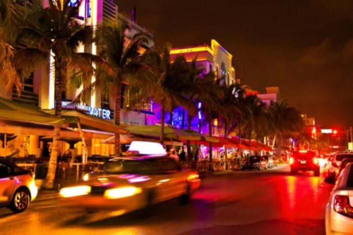 Palm-lined Miami restaurant street at night with a headline announcing the city’s No. 1 ranking for foodies.