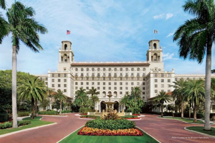 The Breakers Palm Beach entrance, with twin towers, palm trees and a central fountain.