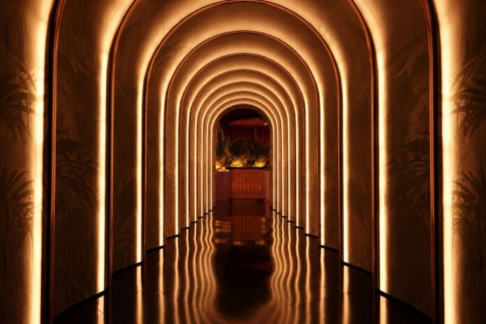 Architectural rendering of the illuminated bronze archway entrance to Macs 44, a new luxury nightlife destination opening in West Palm Beach's Nora District in December 2026.