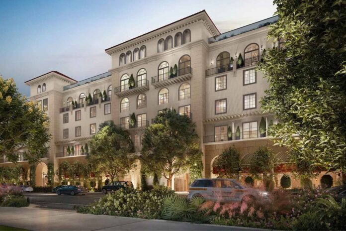 The Nora Hotel in West Palm Beach at dusk, featuring Mediterranean-inspired architecture and illuminated guest rooms.